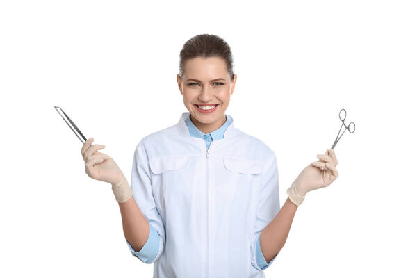 Female dentist holding professional tools on white background