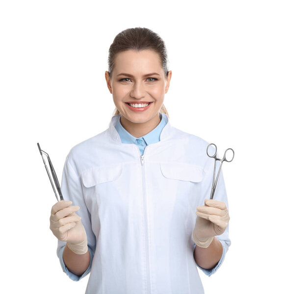 Female dentist holding professional tools on white background