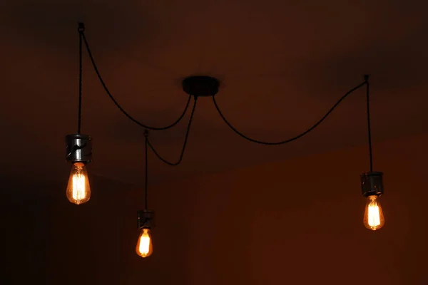 Lamp bulbs on ceiling in dark room