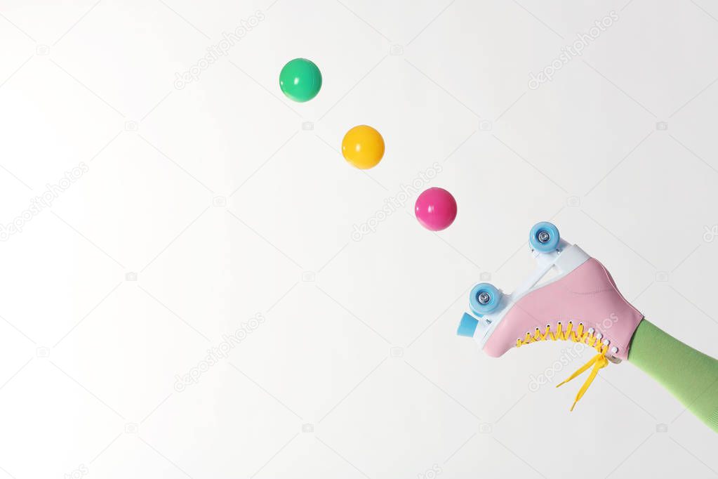 Woman with vintage roller skate and balls on white background, closeup. Space for text