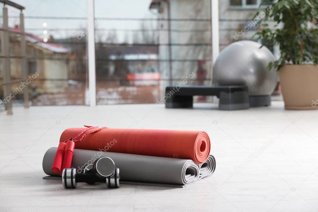 Set of fitness equipment of floor indoors. Space for text