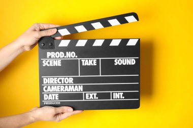 Klaket renk arka planda, closeup tutan kadın. Sinema üretim