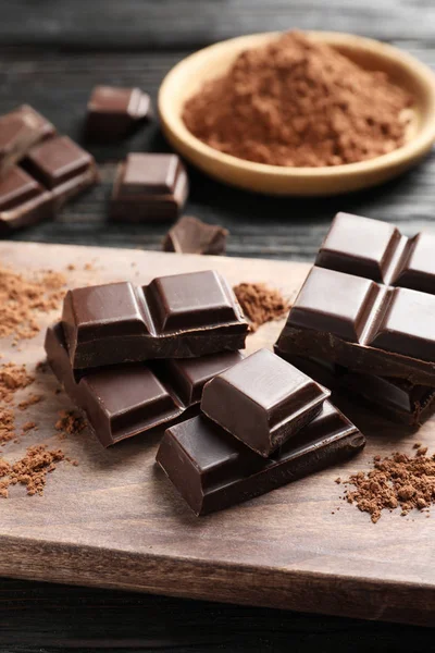 Siyah Ahşap Tahta Üzerinde Çikolata Parçalarını — Stok fotoğraf