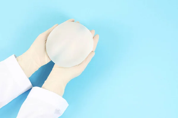 Doctor Holding Silicone Implant Breast Augmentation Color Background Top View — Stock Photo, Image