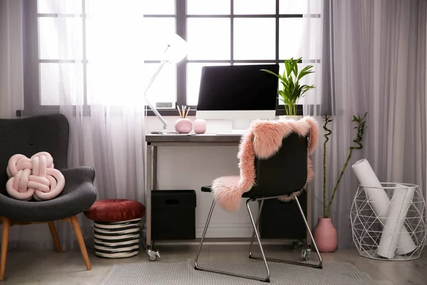 Stylish workplace with computer near window at home office. Space for text