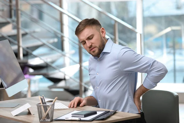 職場で背中の痛みに苦しむビジネスマン — ストック写真