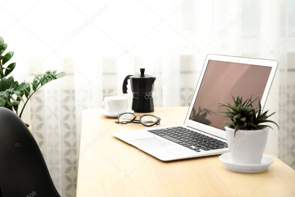 Cozy blogger workplace with laptop at home