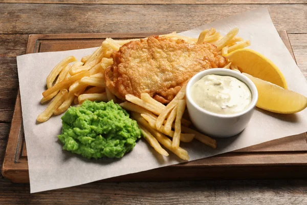 British traditional fish and potato chips on wooden table