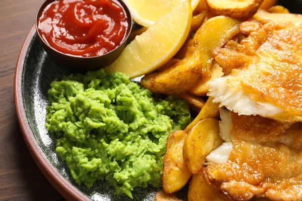 Plate with British traditional fish and potato chips, closeup