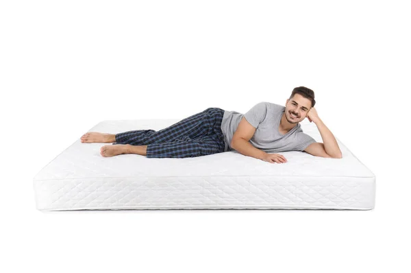 Jeune Homme Couché Sur Matelas Sur Fond Blanc — Photo