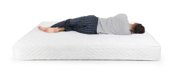 Jeune Homme Couché Sur Matelas Sur Fond Blanc — Photo