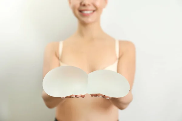 Woman Holding Silicone Implants Breast Augmentation White Background Closeup Cosmetic — Stock Photo, Image