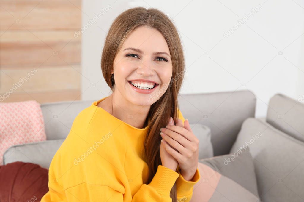 Portrait of young woman laughing at home