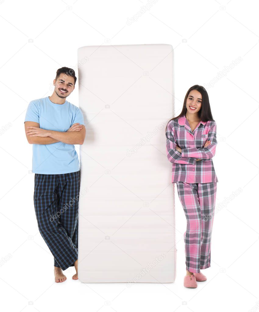 Young woman with comfortable mattress isolated on white