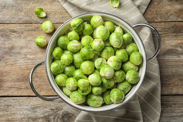 Durkslag Med Brysselkål Trä Bakgrund Ovanifrån — Stockfoto