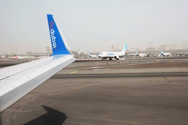 DUBAI, UNITED ARAB EMIRATES - NOVEMBER 06, 2018: View of airport landing zone from Flydubai plane clipart