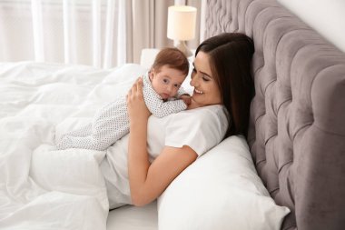 Şirin bebeği yatakta mutlu kadınla