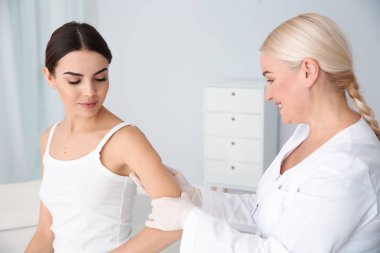 Klinikte genç hastanın Doğum lekesi inceleyerek dermatolog