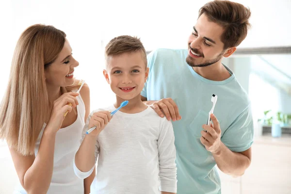 Happy family with toothbrushes in bathroom. Personal hygiene