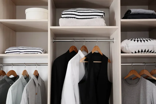 Stylish clothes and home stuff in large wardrobe closet