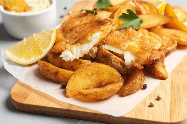 British traditional fish and potato chips on table, closeup