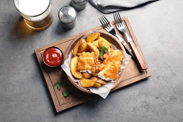 Tasty British traditional fish and potato chips on table, top view