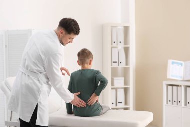 Chiropractor inceleyerek çocuk kliniğinde bel ağrısı ile