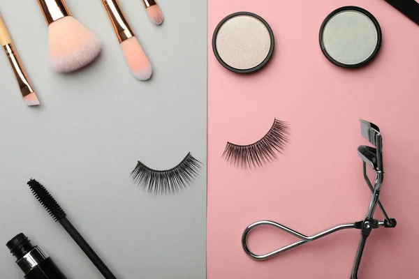 Flat lay composition with artificial eyelashes and accessories on color background