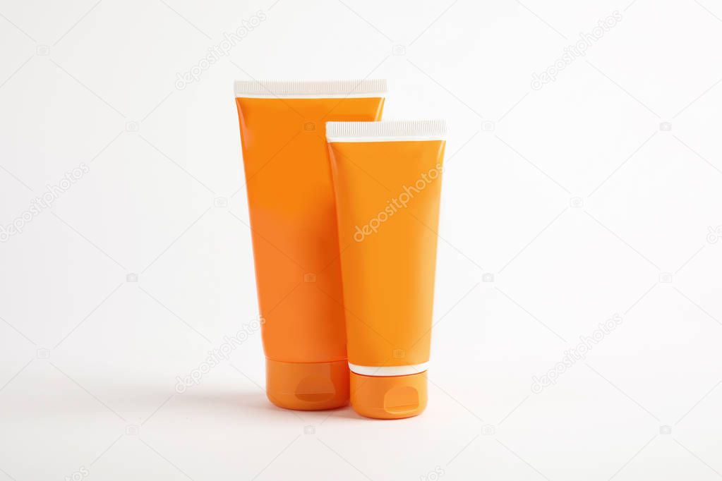 Tubes with sun protection body cream on white background