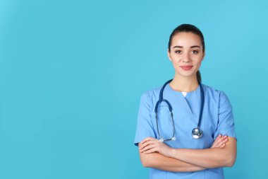 Renk arka plan üzerinde üniformalı genç tıp öğrencisi. Metin için yer