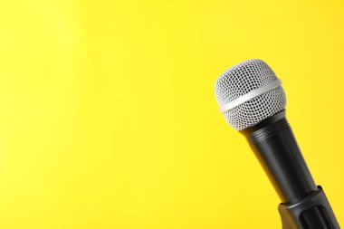 Dynamic microphone on color background, space for text clipart