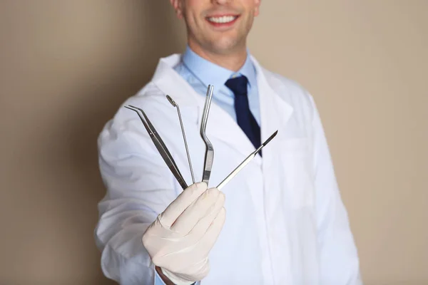 Male Dentist Holding Professional Tools Color Background Closeup — Stock Photo, Image