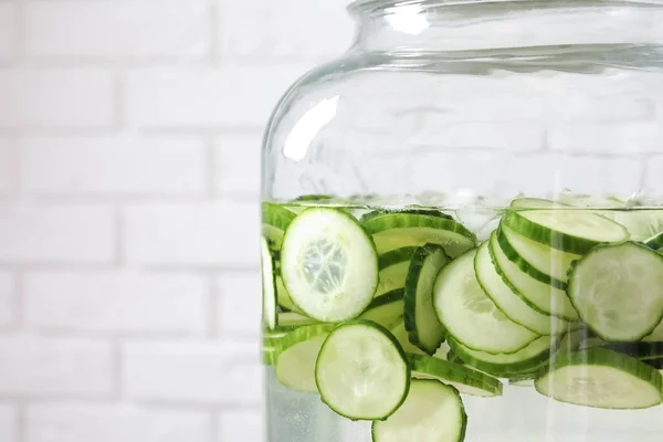 Large jar of fresh cucumber water, closeup. Space for text