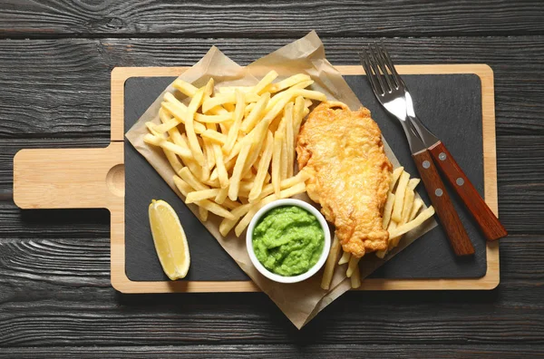 British Traditional Fish and potato chips on wooden background, top view