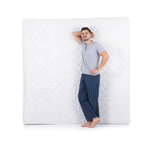 Junger Mann Mit Bequemer Matratze Isoliert Auf Weiß — Stockfoto