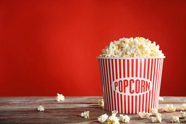 Bucket Tasty Popcorn Table Red Background Space Text Watching Cinema — Stock Photo, Image