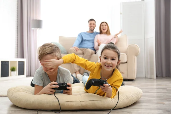 Crianças Bonitas Jogando Videogames Enquanto Pais Descansam Sofá Casa — Fotografia de Stock