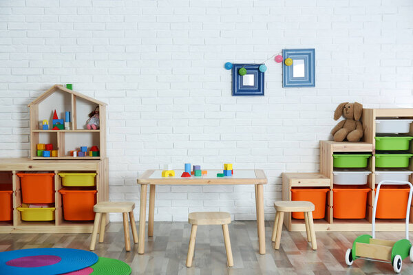 Modern child room interior with table and stools