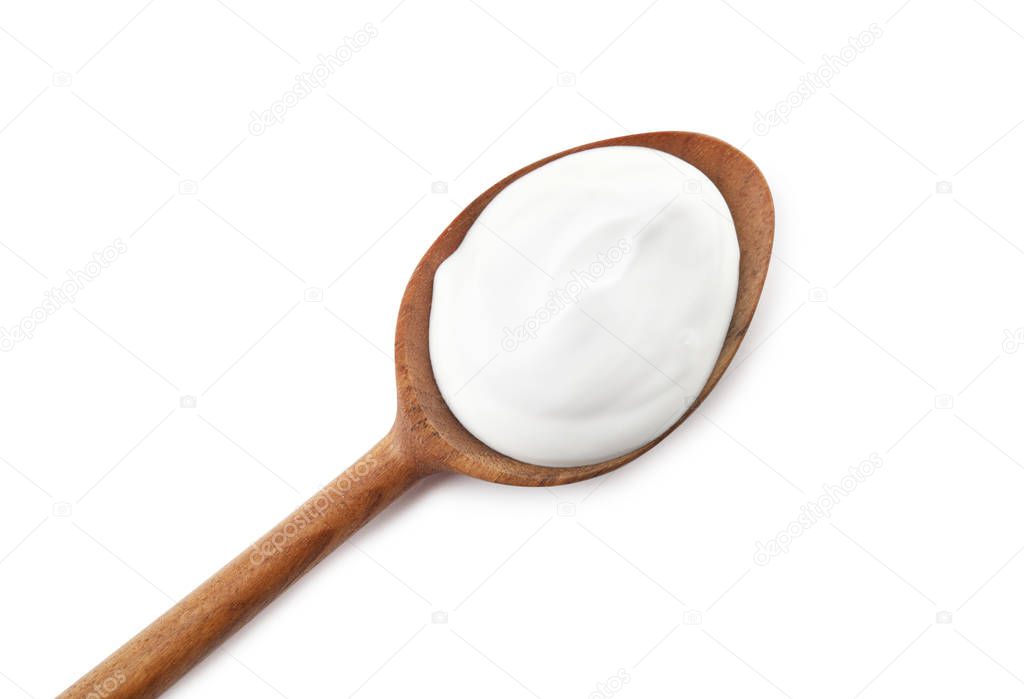 Spoon with creamy yogurt on white background, top view