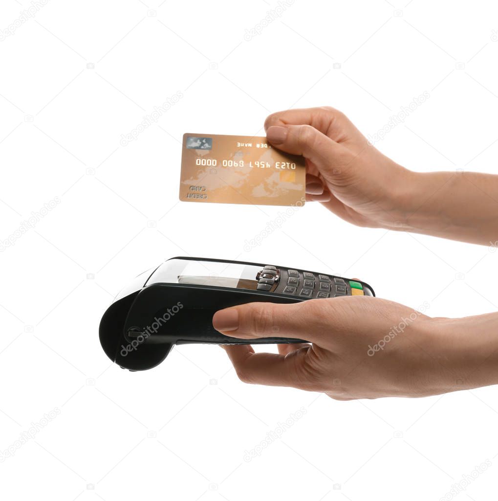 Woman holding payment terminal and credit card on white background, closeup