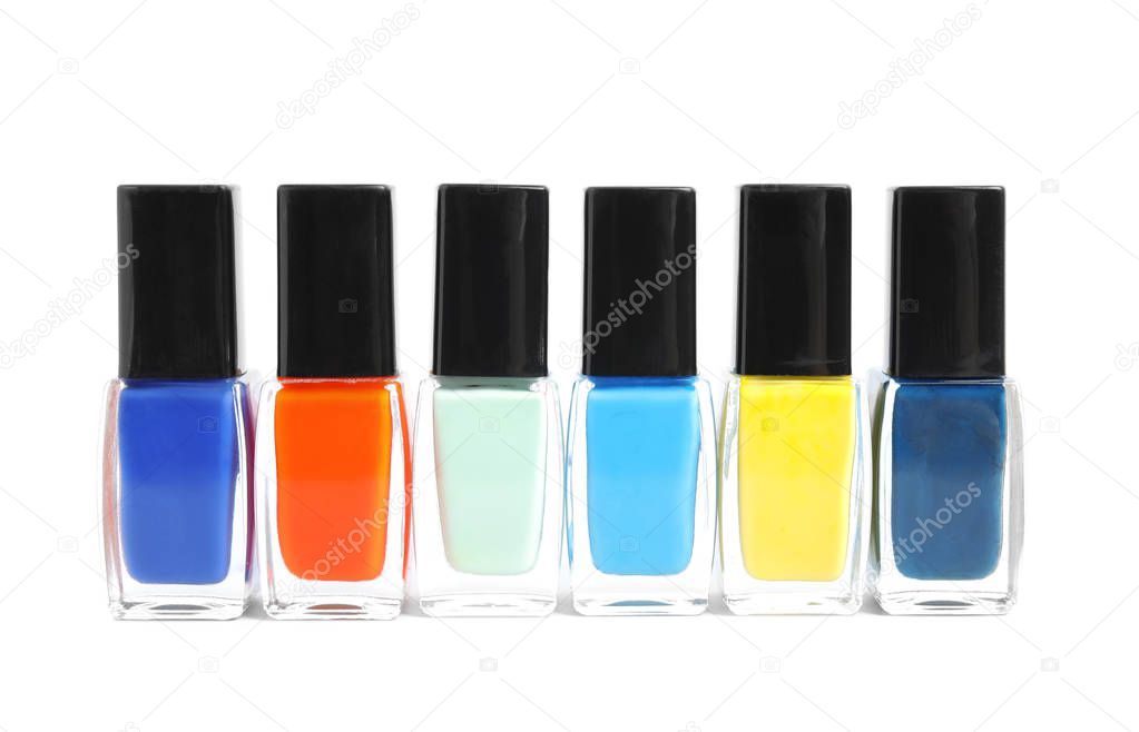 Bottles of nail polish on white background