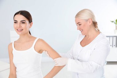 Klinikte genç hastanın Doğum lekesi inceleyerek dermatolog