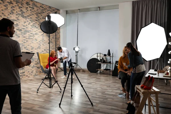 Photo studio with professional equipment and team of workers