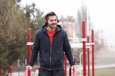 Müzik ve spor zemin üzerinde egzersiz kulaklık ile genç adam