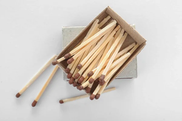 Cardboard box with matches on white background, top view