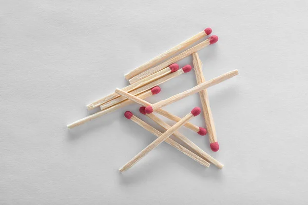 Pile of wooden matches on white background, top view