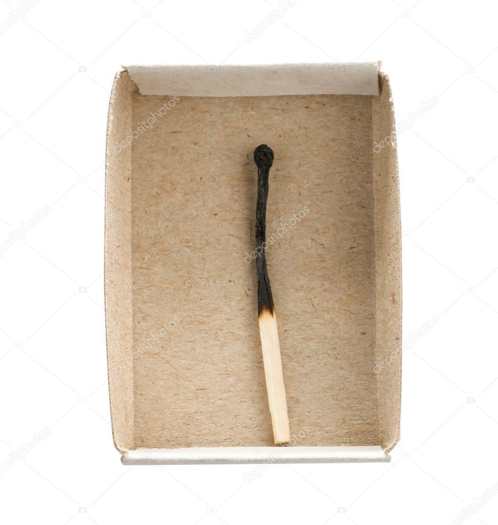 Cardboard box with burnt match on white background, top view
