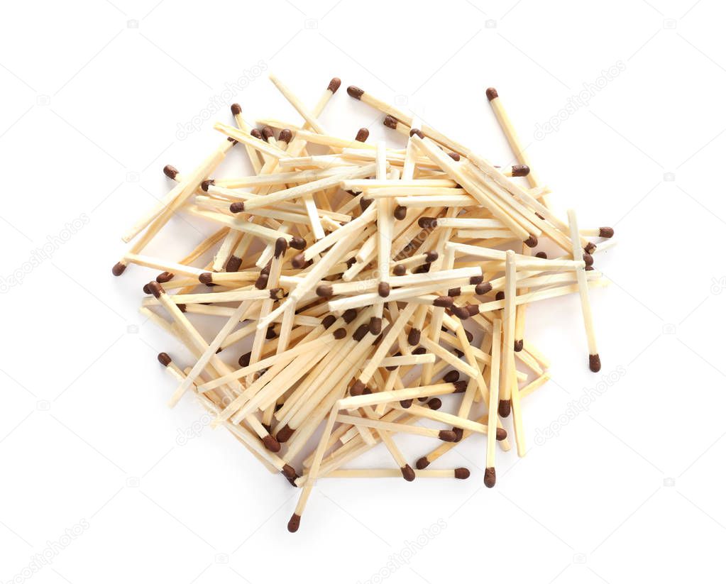 Pile of wooden matches on white background, top view