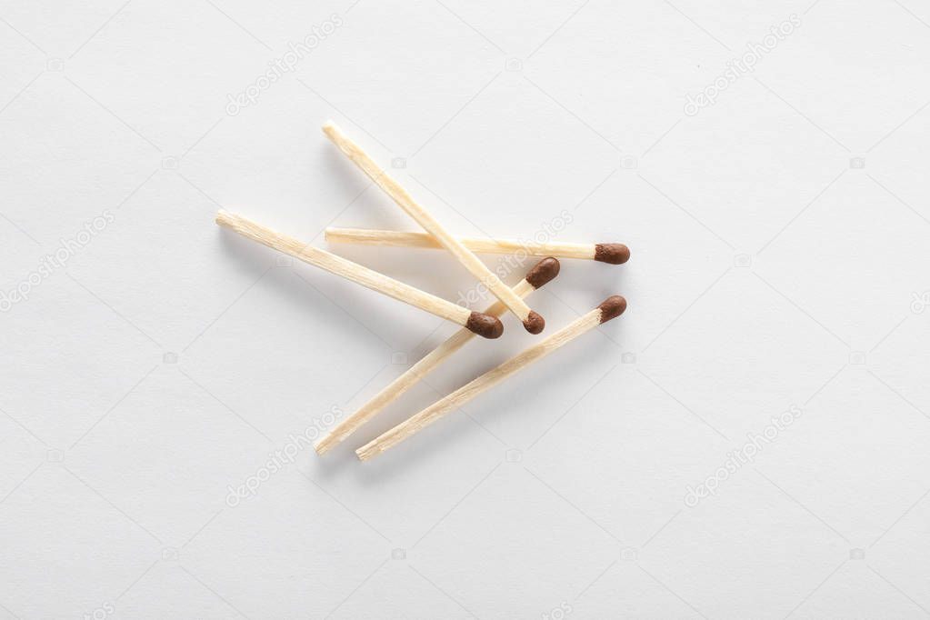 Wooden matches on white background, top view