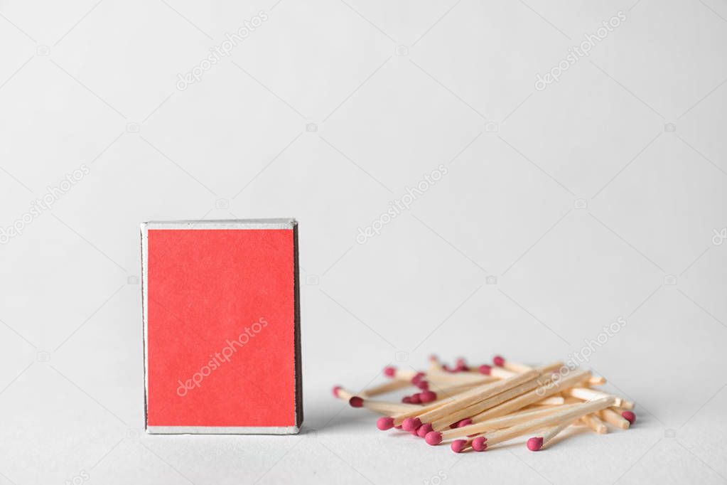 Cardboard box and matches on light background. Space for design